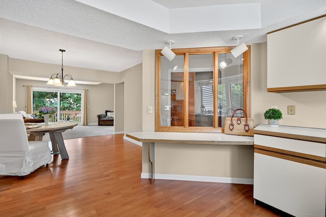 55 Wickhams Fancy Unit 55, Canton, CT 06019 - kitchen featuring light countertops, light wood-style flooring, open floor plan, a chandelier, and a textured ceiling