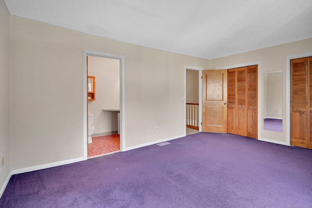 55 Wickhams Fancy Unit 55, Canton, CT 06019 - unfurnished bedroom with dark colored carpet, multiple closets, and connected bathroom