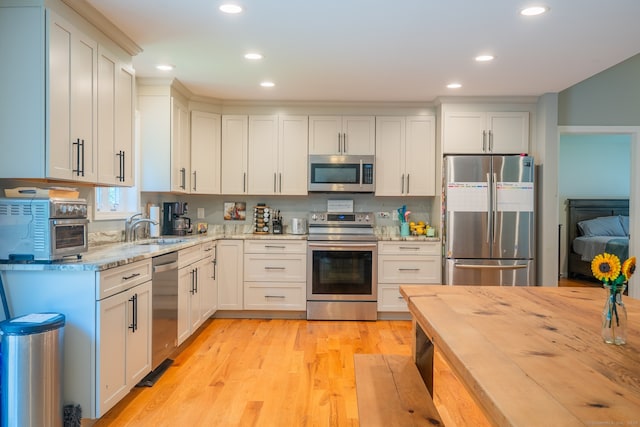 81 Lillis Rd, New Milford, CT 06776 - kitchen featuring appliances with stainless steel finishes, light stone countertops, recessed lighting, and white cabinetry