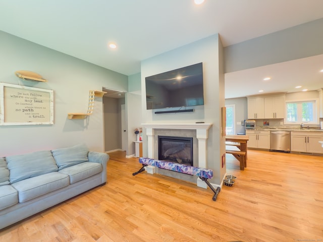 81 Lillis Rd, New Milford, CT 06776 - living room featuring light wood-style floors, a glass covered fireplace, and recessed lighting