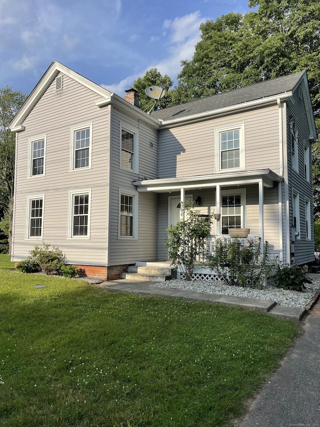 56 N Maple St, Enfield, CT 06082 - view of front facade with a porch, a chimney, and a front lawn