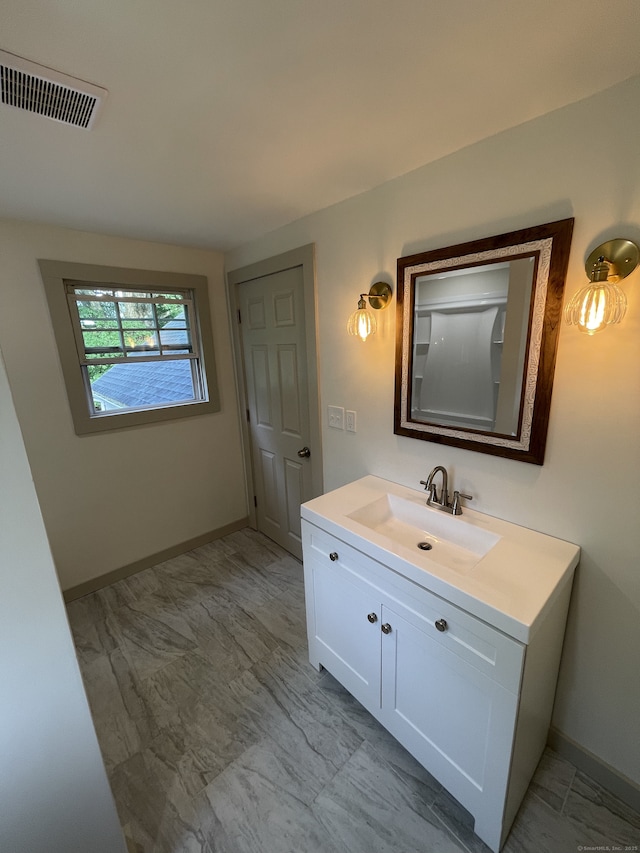 56 N Maple St, Enfield, CT 06082 - bathroom featuring marble finish floors and vanity