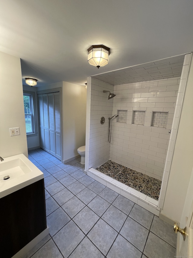 56 N Maple St, Enfield, CT 06082 - full bath with a tile shower, vanity, and tile patterned floors