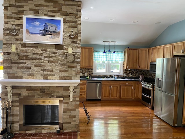 18 Bch Park Rd, Clinton, CT 06413 - kitchen with appliances with stainless steel finishes, light wood finished floors, tasteful backsplash, vaulted ceiling, and dark countertops