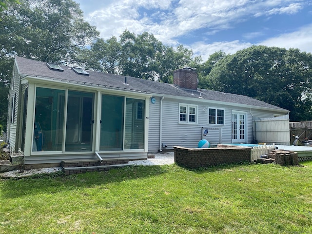 18 Bch Park Rd, Clinton, CT 06413 - rear view of property with a chimney, a sunroom, and a yard