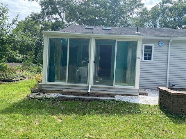 18 Bch Park Rd, Clinton, CT 06413 - back of property featuring a sunroom, a lawn, and roof with shingles