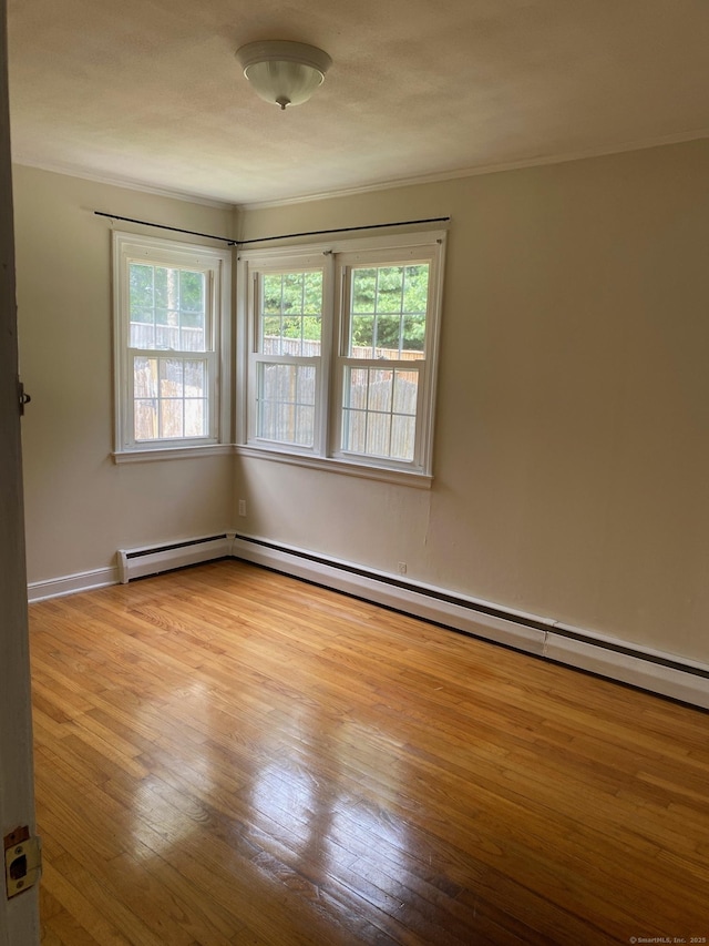 18 Bch Park Rd, Clinton, CT 06413 - spare room featuring hardwood / wood-style flooring, healthy amount of natural light, ornamental molding, and a baseboard radiator