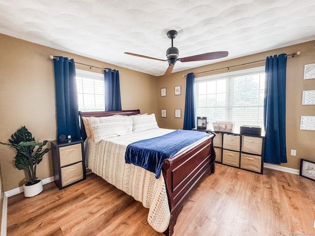 60 Sachem Dr Unit 60, Plainfield, CT 06374 - bedroom featuring light wood finished floors, multiple windows, and ceiling fan