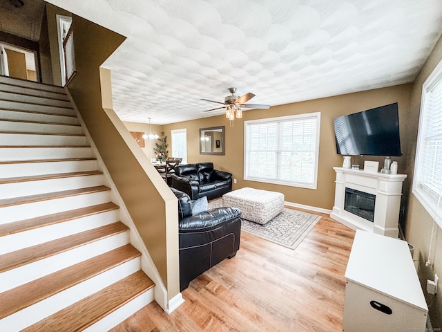 60 Sachem Dr Unit 60, Plainfield, CT 06374 - living room featuring stairway, plenty of natural light, light wood-type flooring, and a glass covered fireplace