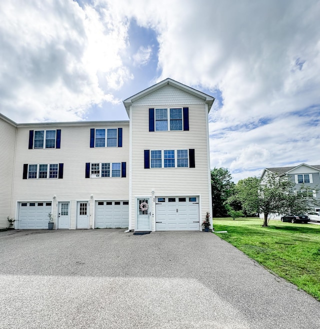 60 Sachem Dr Unit 60, Plainfield, CT 06374 - view of front of home featuring an attached garage, driveway, and a front yard