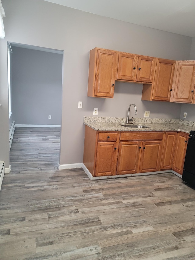 41 Mahl Ave, Hartford, CT 06154 - kitchen with stove, light wood-type flooring, a baseboard radiator, and light stone countertops