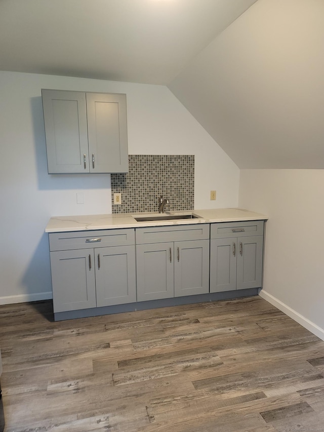 41 Mahl Ave, Hartford, CT 06154 - kitchen featuring gray cabinets, light wood-style floors, decorative backsplash, light countertops, and vaulted ceiling