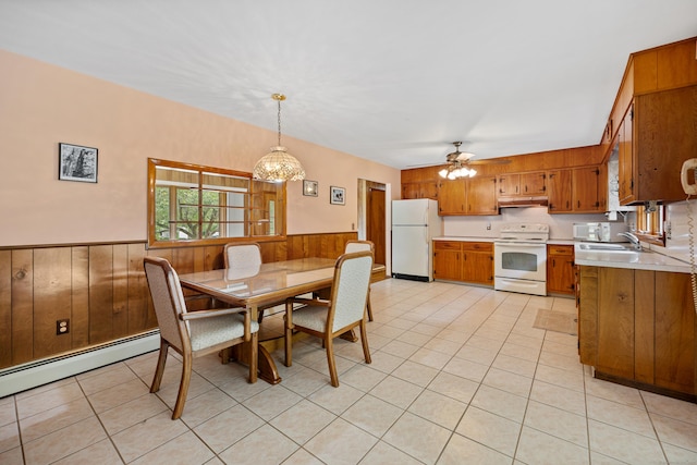 233 Mountain Rd, Cheshire, CT 06410 - dining room with wainscoting, wooden walls, a baseboard heating unit, a ceiling fan, and light tile patterned floors