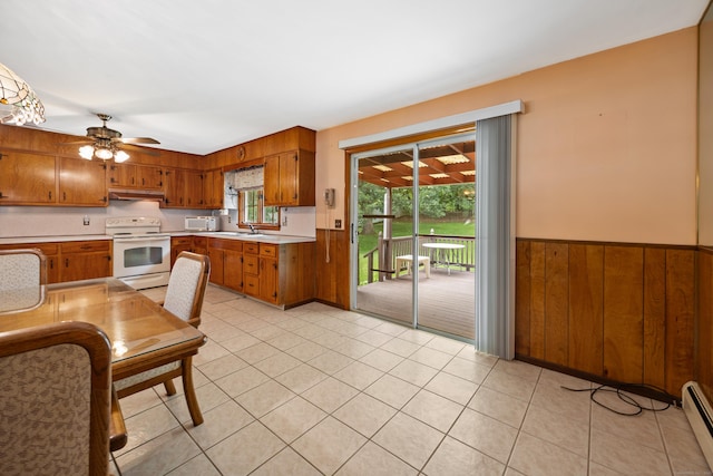 233 Mountain Rd, Cheshire, CT 06410 - kitchen with white appliances, brown cabinets, under cabinet range hood, light countertops, and wainscoting