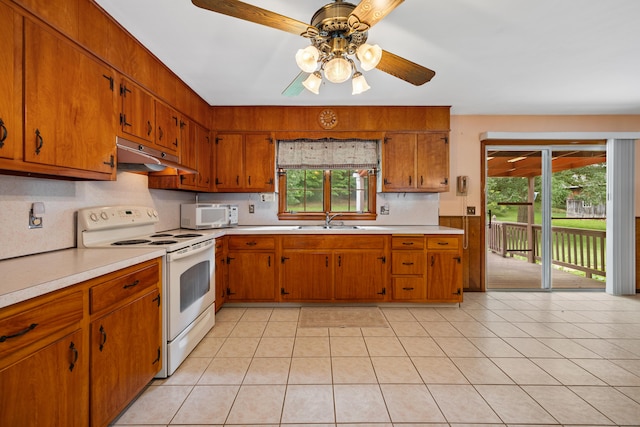 233 Mountain Rd, Cheshire, CT 06410 - kitchen featuring white appliances, under cabinet range hood, light countertops, ceiling fan, and decorative backsplash