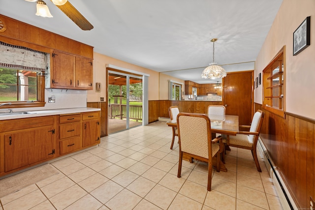 233 Mountain Rd, Cheshire, CT 06410 - dining room with wood walls, wainscoting, a baseboard heating unit, light tile patterned flooring, and a ceiling fan