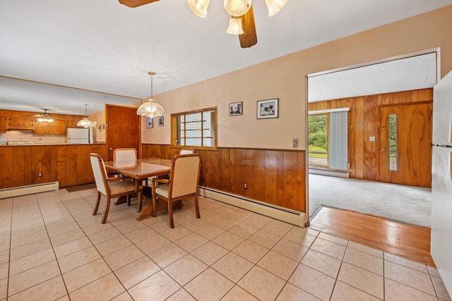 233 Mountain Rd, Cheshire, CT 06410 - dining room featuring a baseboard radiator, wood walls, ceiling fan, wainscoting, and light tile patterned flooring