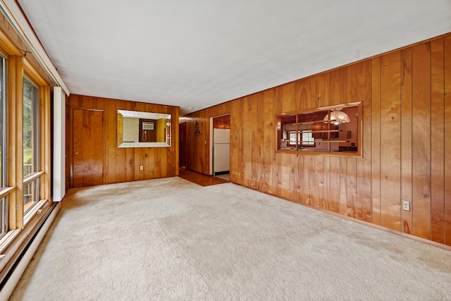 233 Mountain Rd, Cheshire, CT 06410 - spare room featuring baseboard heating, wooden walls, carpet floors, and a chandelier