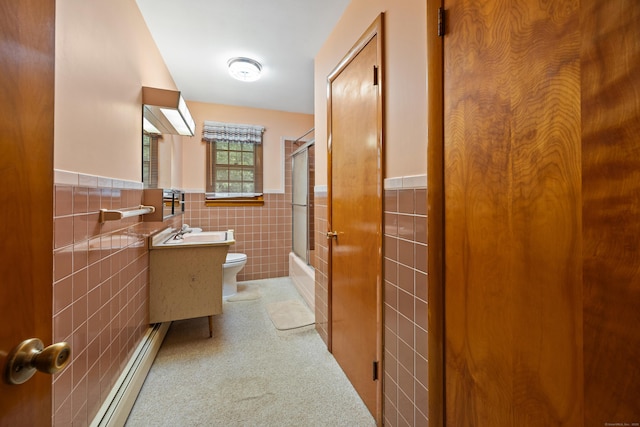 233 Mountain Rd, Cheshire, CT 06410 - full bathroom featuring tile walls, a baseboard radiator, vanity, bath / shower combo with glass door, and a wainscoted wall