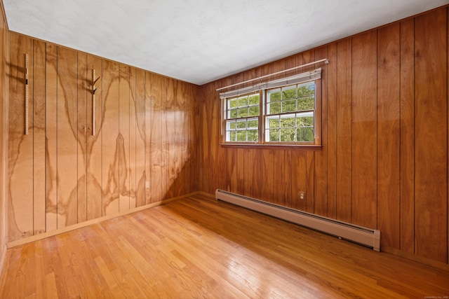 233 Mountain Rd, Cheshire, CT 06410 - spare room with a baseboard radiator, wood finished floors, and wood walls