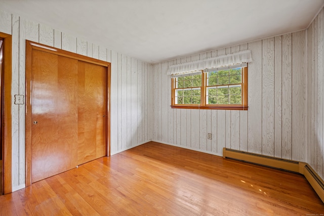 233 Mountain Rd, Cheshire, CT 06410 - empty room featuring wood finished floors and a baseboard heating unit