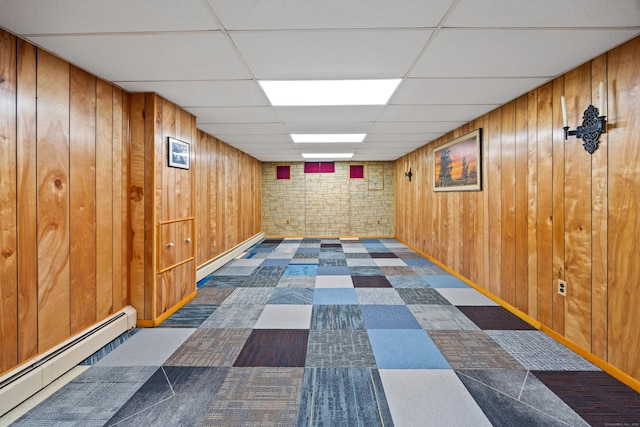 233 Mountain Rd, Cheshire, CT 06410 - finished basement with a baseboard radiator, a drop ceiling, wooden walls, and tile patterned floors