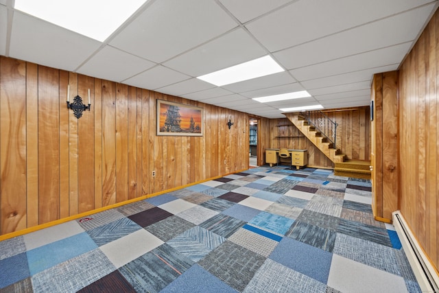 233 Mountain Rd, Cheshire, CT 06410 - finished below grade area with a baseboard radiator, stairway, wood walls, and a paneled ceiling