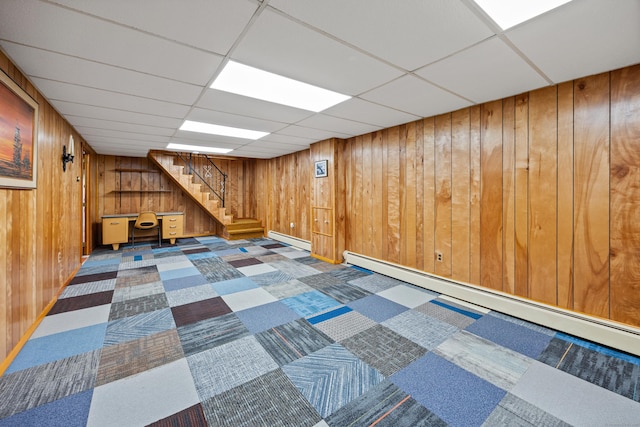 233 Mountain Rd, Cheshire, CT 06410 - finished below grade area featuring a baseboard radiator, wooden walls, baseboard heating, a paneled ceiling, and stairway