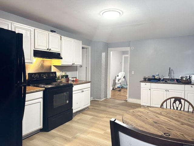 98 Sylvan Ave, New Haven, CT 06519 - kitchen featuring black appliances, under cabinet range hood, white cabinets, dark countertops, and light wood finished floors