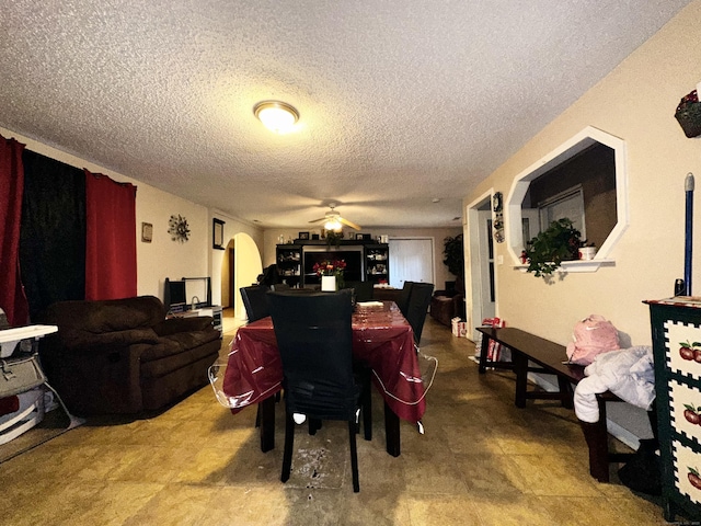 98 Sylvan Ave, New Haven, CT 06519 - dining area featuring a textured ceiling, ceiling fan, and arched walkways