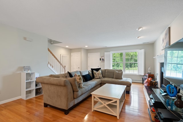 11 Adam Dr, Newington, CT 06111 - living area with stairs, light wood-type flooring, baseboard heating, recessed lighting, and a fireplace