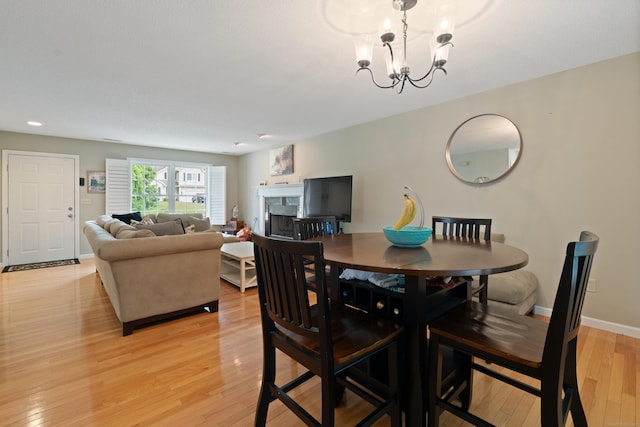 11 Adam Dr, Newington, CT 06111 - dining area featuring light wood-type flooring, a chandelier, a fireplace, and recessed lighting