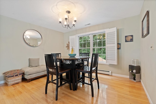11 Adam Dr, Newington, CT 06111 - dining area featuring light wood-style flooring, a baseboard heating unit, and a chandelier
