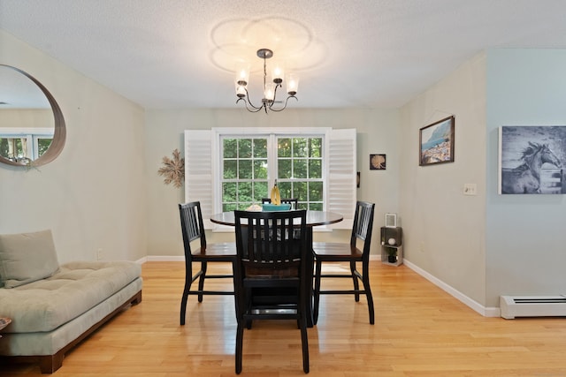 11 Adam Dr, Newington, CT 06111 - dining area with baseboard heating, a chandelier, light wood finished floors, and a textured ceiling