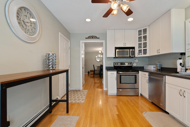 11 Adam Dr, Newington, CT 06111 - kitchen featuring appliances with stainless steel finishes, dark countertops, light wood-type flooring, a ceiling fan, and glass insert cabinets