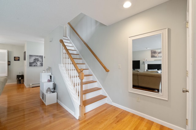 11 Adam Dr, Newington, CT 06111 - stairs with baseboard heating, wood finished floors, and a fireplace