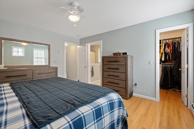 11 Adam Dr, Newington, CT 06111 - bedroom featuring a spacious closet, light wood-style flooring, a closet, ceiling fan, and a baseboard heating unit