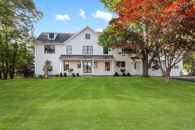 52 Garibaldi Ln, New Canaan, CT 06840 - modern farmhouse style home featuring a standing seam roof, board and batten siding, a metal roof, and a front lawn