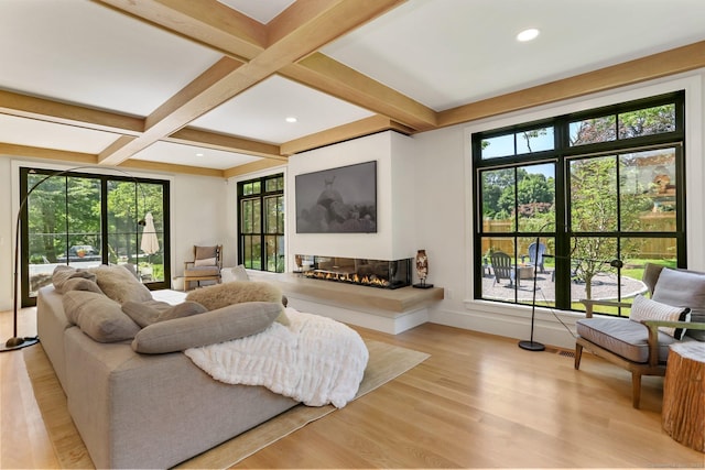 52 Garibaldi Ln, New Canaan, CT 06840 - living area with healthy amount of natural light, wood finished floors, coffered ceiling, beam ceiling, and a glass covered fireplace