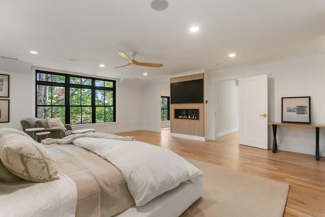 52 Garibaldi Ln, New Canaan, CT 06840 - bedroom featuring recessed lighting, light wood finished floors, a fireplace, and ornamental molding