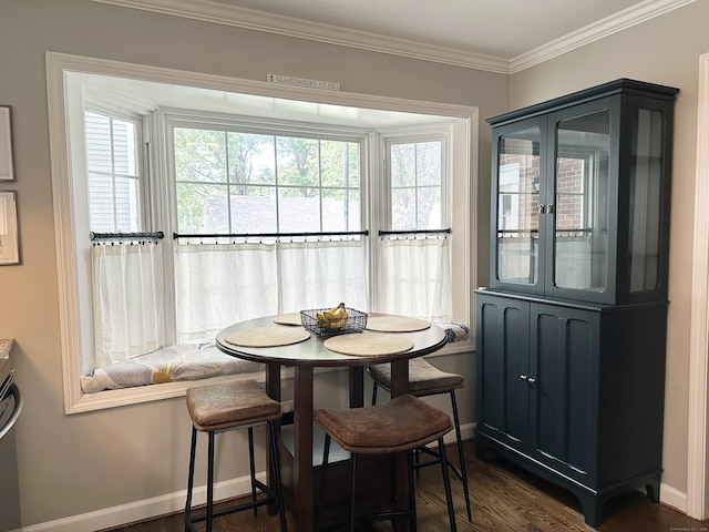 311 Georgetown Dr Unit 311, Glastonbury, CT 06033 - dining area featuring dark wood-type flooring, crown molding, and breakfast area