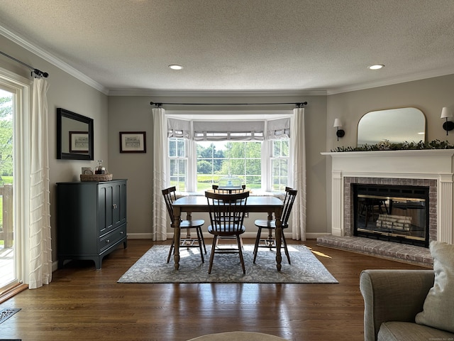 311 Georgetown Dr Unit 311, Glastonbury, CT 06033 - dining space with ornamental molding, healthy amount of natural light, a textured ceiling, dark wood-type flooring, and a brick fireplace