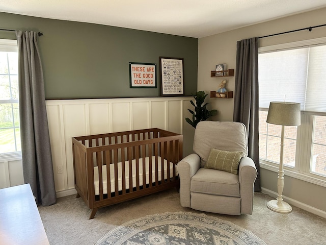 311 Georgetown Dr Unit 311, Glastonbury, CT 06033 - carpeted bedroom with multiple windows, a crib, and a wainscoted wall