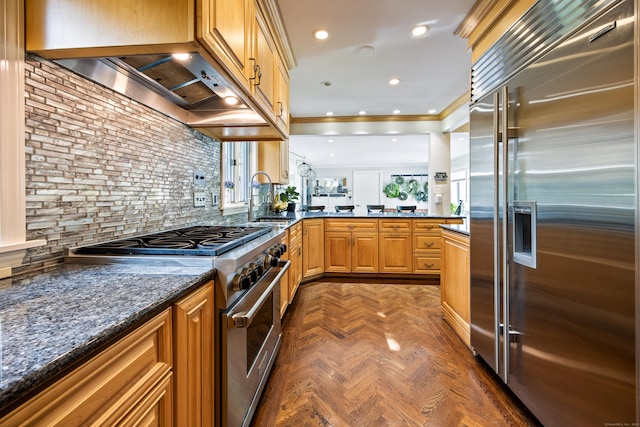 430 Cook Hill Rd, Cheshire, CT 06410 - kitchen with high end appliances, ornamental molding, wall chimney range hood, a peninsula, and dark stone counters