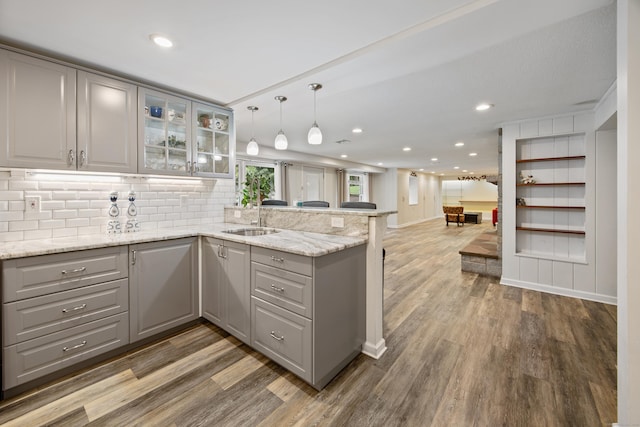 430 Cook Hill Rd, Cheshire, CT 06410 - kitchen featuring gray cabinets, a peninsula, wood finished floors, glass insert cabinets, and recessed lighting