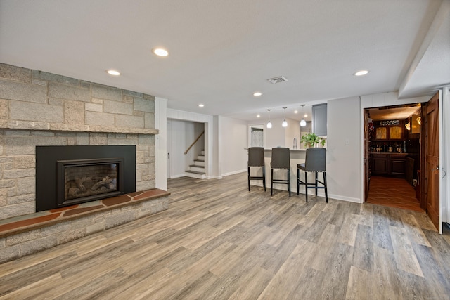 430 Cook Hill Rd, Cheshire, CT 06410 - living area featuring recessed lighting, wood finished floors, stairway, a fireplace, and bar area