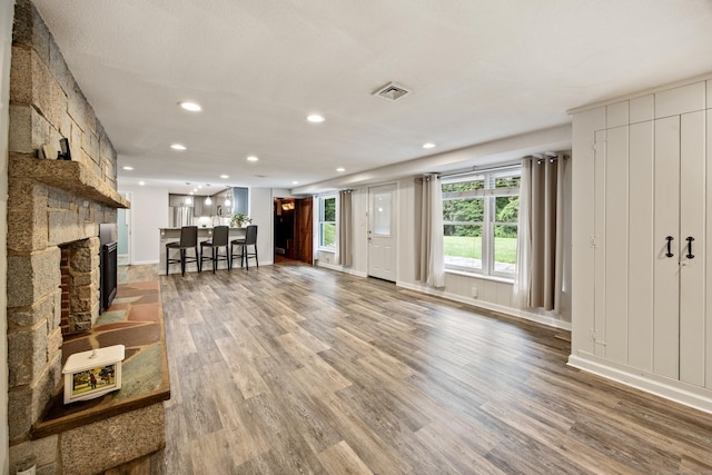 430 Cook Hill Rd, Cheshire, CT 06410 - living room featuring wood finished floors, recessed lighting, and a stone fireplace