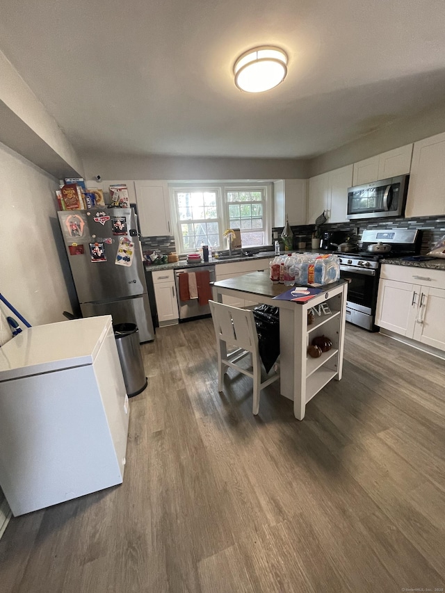 104 Terrace Ave, West Haven, CT 06516 - kitchen with stainless steel appliances, dark wood-style flooring, dark countertops, white cabinets, and open shelves
