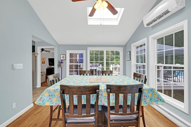 24 Saley Rd, Milford, CT 06460 - dining area with an AC wall unit, lofted ceiling, ceiling fan, a skylight, and light wood-type flooring