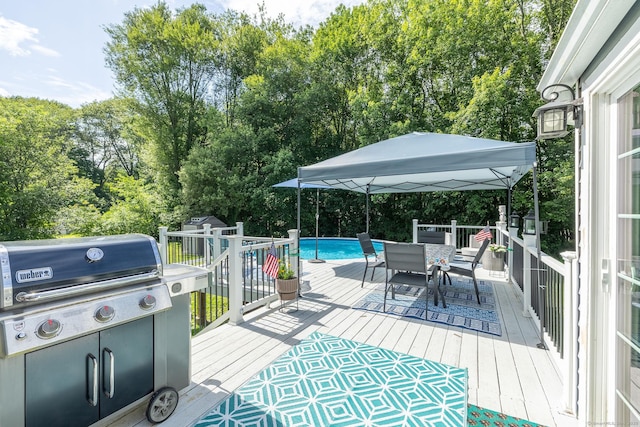 24 Saley Rd, Milford, CT 06460 - wooden terrace with an outdoor pool, outdoor dining area, view of wooded area, and area for grilling